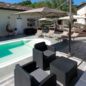 Vista piscina e tavolini in primo piano